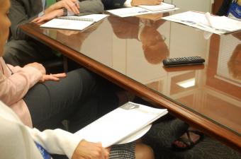 CEC advocates sitting around legislative table with issue briefs